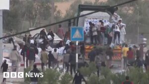 Crowds scramble to grab aid from moving lorries in Gaza