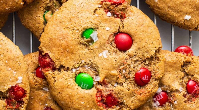 Christmas cookies with m&ms on a cooling rack.