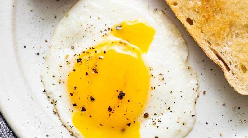 A sunny side up egg on a plate.