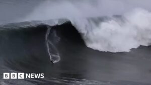 Surfers brave huge waves as storm batters US coast