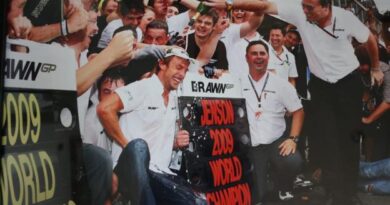 Dave Freeman pours champagne over Jenson Button