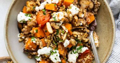 A bowl of quinoa and squash with feta and nuts.