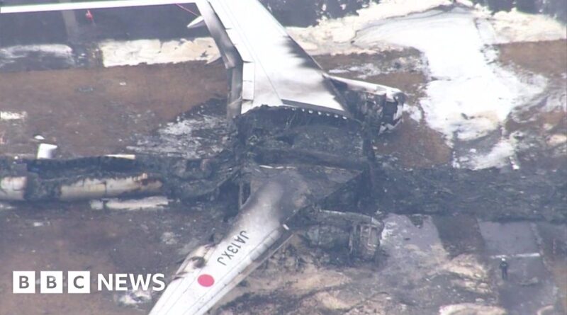 Aerial footage shows burned out shell of Japan plane