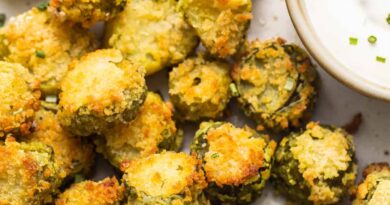 A plate of fried brussel sprouts with dipping sauce.