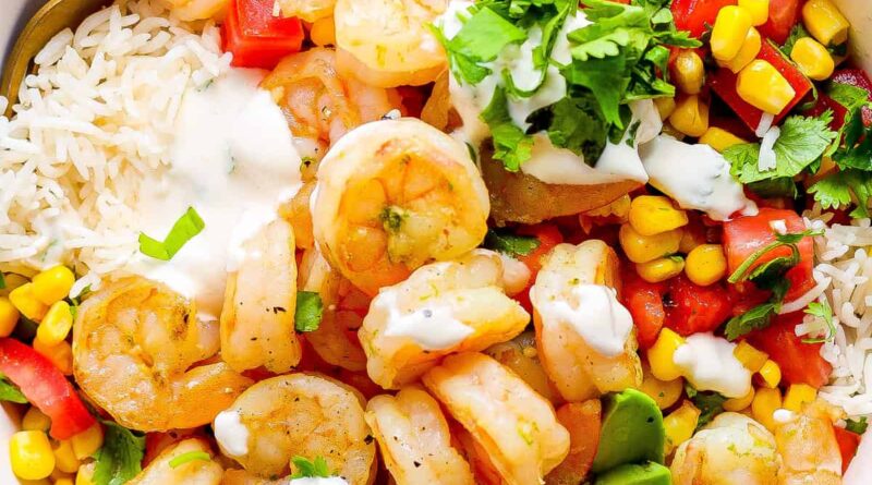 A white bowl with shrimp, rice and vegetables.