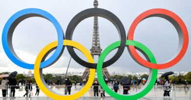 Olympic rings in Paris, with Eiffel Tower in background