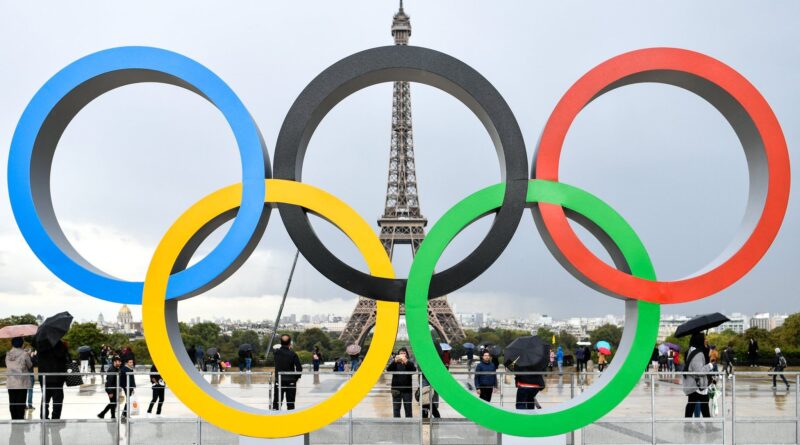 Olympic rings in Paris, with Eiffel Tower in background