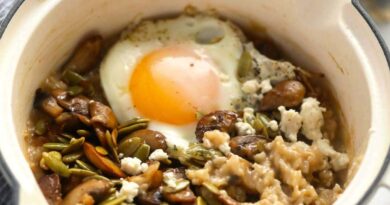 a bowl of oatmeal with a fried egg on top.