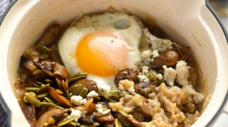 a bowl of oatmeal with a fried egg on top.