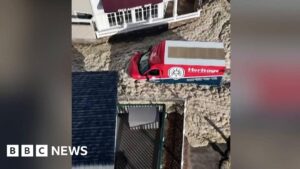 Video shows cars driving through sea foam after storm