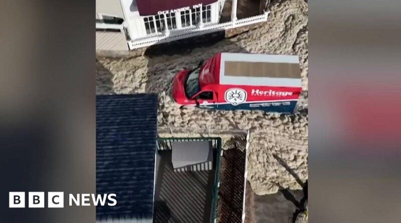 Video shows cars driving through sea foam after storm