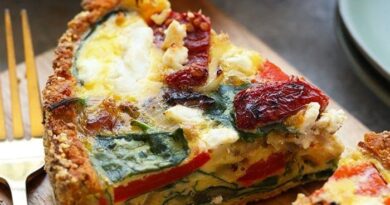 A slice of sweet potato crust quiche on a cutting board.