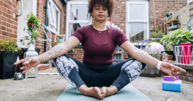 Yoga teacher demonstrating butterfly pose