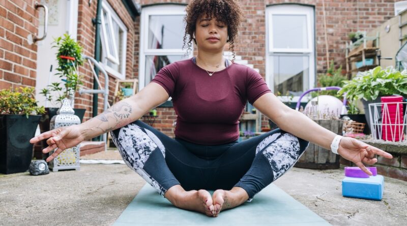 Yoga teacher demonstrating butterfly pose