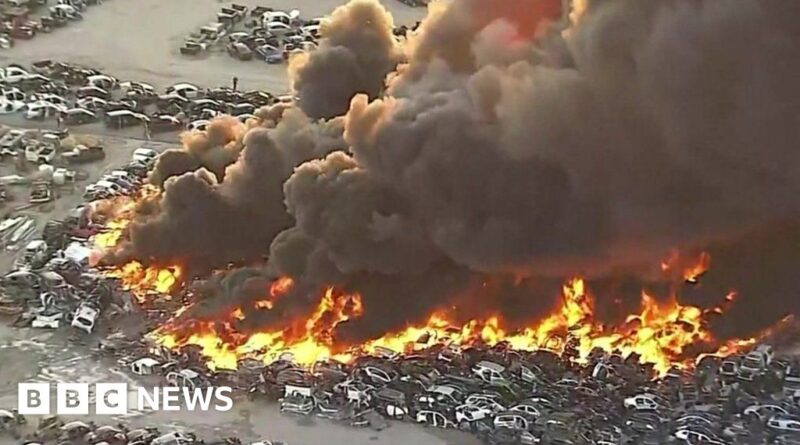 Scores of cars on fire in junkyard blaze