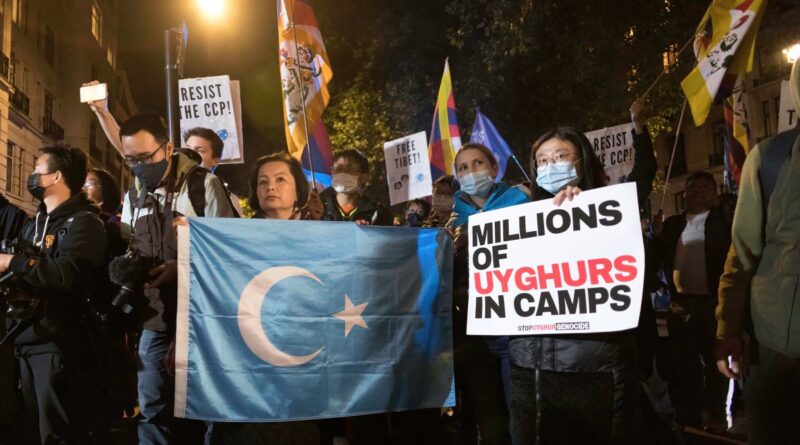 Rahima Mahmut (L), UK director of World Uyghur Congress holds an East Turkestan Flag during the demonstration. On October 1st, various anti-China Diasporas in London came together in solidarity against the Chinese Communist Party.