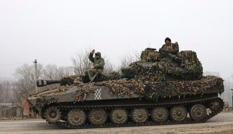 In this photo taken from video distributed by Russian Defense Ministry Press Service on Friday, March 14, 2025, Russian soldiers ride atop of self-propelled gun at an area in the Kursk region of Russia after it was taken over by Russian troops. (Russian Defense Ministry Press Service via AP)