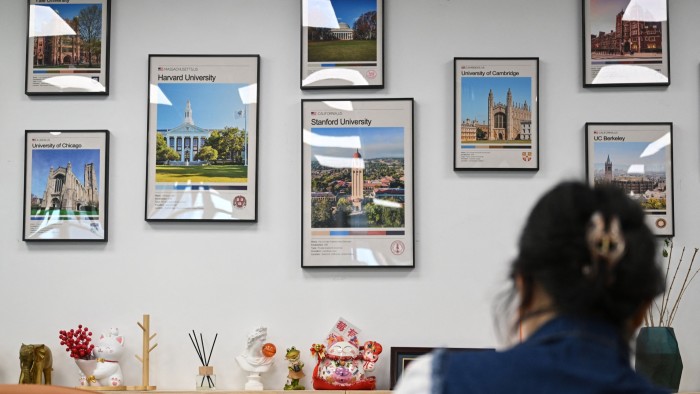 Posters of US universities, including Harvard and Stanford Universities, on display at an overseas education agency in Beijing