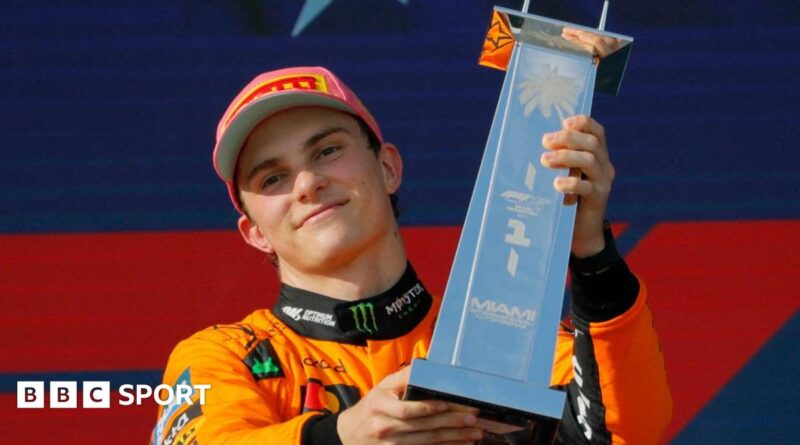 Oscar Piastri lifts the winner's trophy after the Miami Grand Prix
