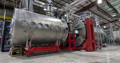 Realta Fusion's device sits in a large warehouse-like building.