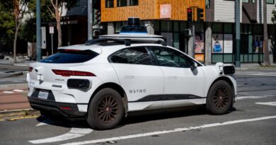 Waymo self driving car waiting at a city intersection in San Francisco