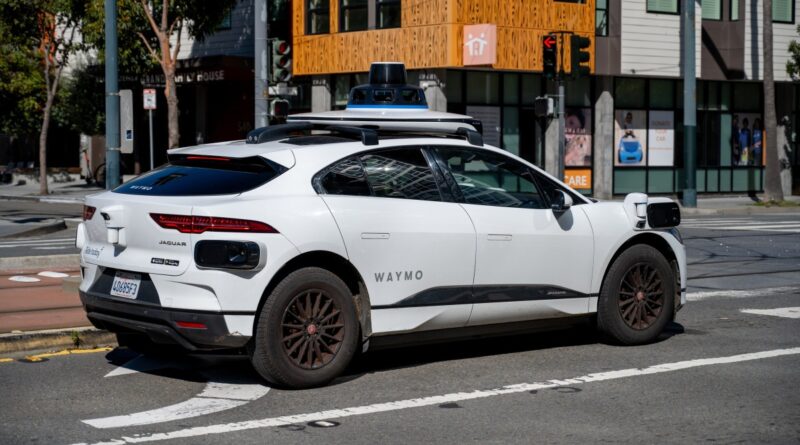 Waymo self driving car waiting at a city intersection in San Francisco