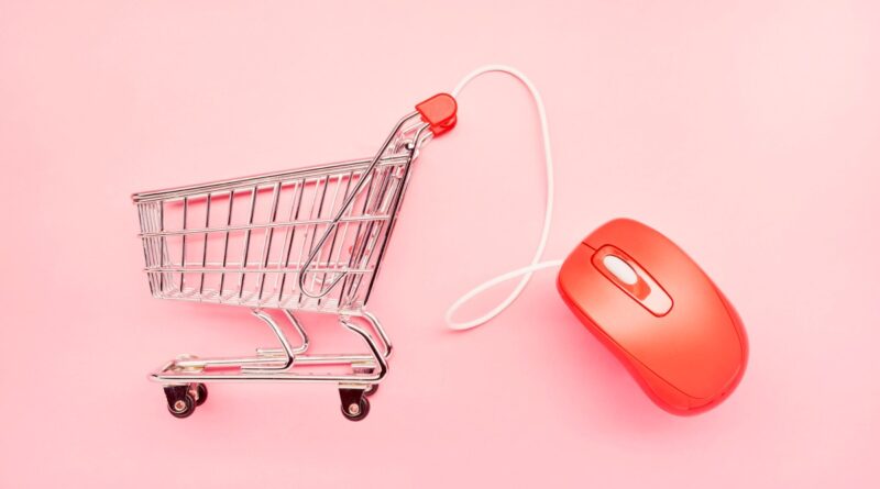 small shopping cart and red computer mouse