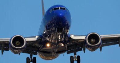 A Southwest passenger kicked and spat at the crew when they tried to stop her from opening an exit in midair, affidavit says