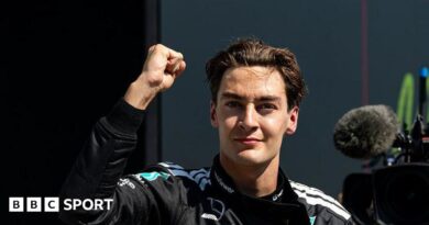 George Russell throwing a fist in the air to celebrate winning the Canadian Grand Prix