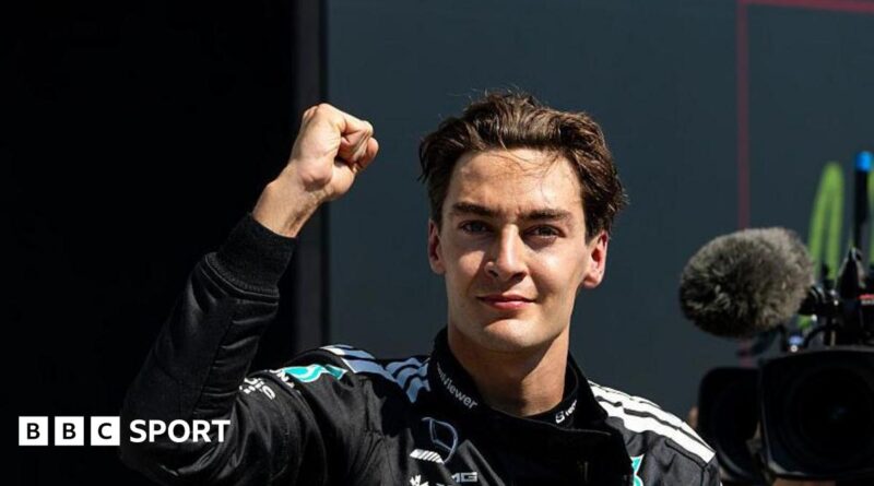 George Russell throwing a fist in the air to celebrate winning the Canadian Grand Prix