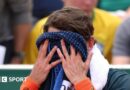 Alex de Minaur covers his face with a towel at the French Open