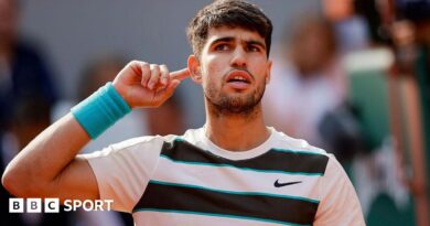 Carlos Alcaraz holds his finger to his ear
