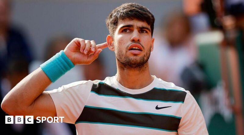 Carlos Alcaraz holds his finger to his ear