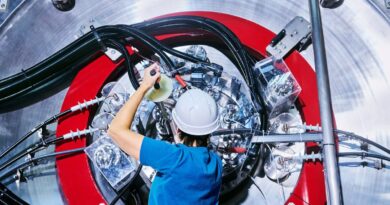 An employee is seen working on TAE Technologies’ fusion energy research device.