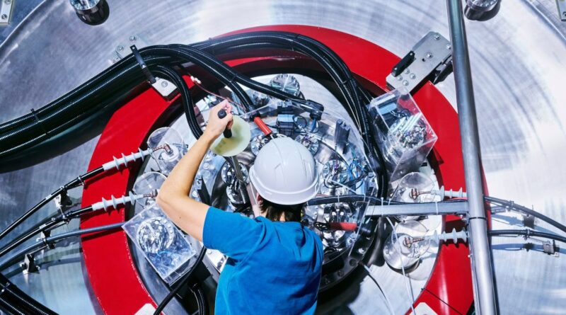 An employee is seen working on TAE Technologies’ fusion energy research device.