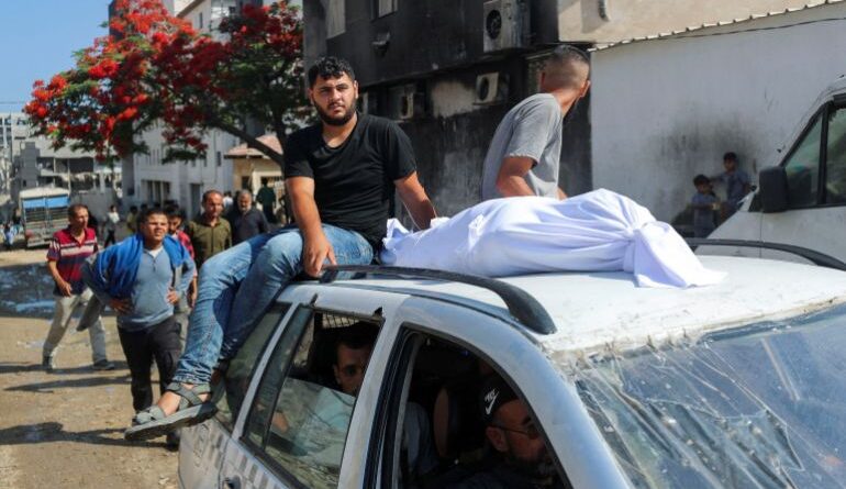 The body of a Palestinian is transported on a car as mourners attend the funeral of Palestinians who were killed, according to medics, in Israeli fire, at Al-Shifa hospital, in Gaza City, June 12, 2025. REUTERS/Mahmoud Issa TPX IMAGES OF THE DAY