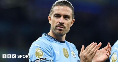 Jack Grealish applauds in Manchester City kit
