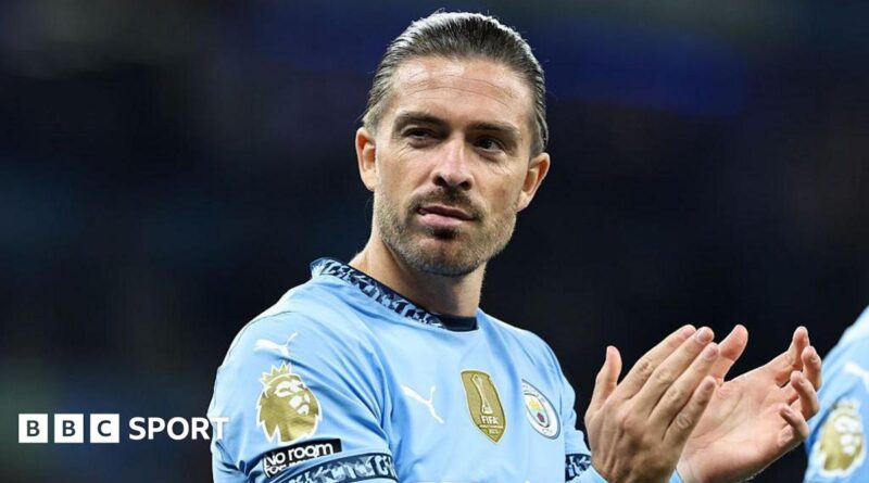 Jack Grealish applauds in Manchester City kit