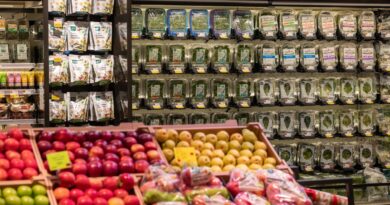 a selection of food items on a store shelf at Whole Foods