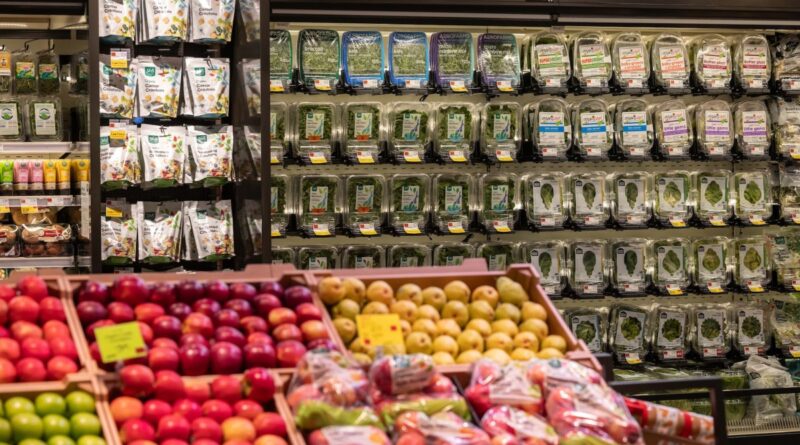 a selection of food items on a store shelf at Whole Foods