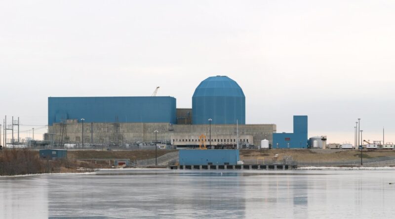 The Clinton Clean Energy Center stands before a frozen lake.