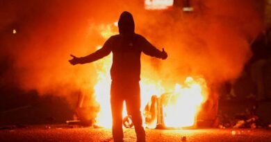 Fire burns near a demonstrator as riots continue in Ballymena, Northern Ireland, June 11, 2025. REUTERS/Clodagh Kilcoyne TPX IMAGES OF THE DAY