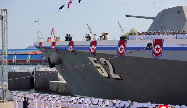 North Korean leader Kim Jong Un waves from on board a warship that had been damaged upon its first attempt to launch, as he and his daughter Kim Ju Ae attend the warship's launching ceremony, in Rajin, North Korea, June 12, 2025 in this photo released by North Korea's official Korean Central News Agency. KCNA via REUTERS ATTENTION EDITORS - THIS IMAGE WAS PROVIDED BY A THIRD PARTY. REUTERS IS UNABLE TO INDEPENDENTLY VERIFY THIS IMAGE. NO THIRD PARTY SALES. SOUTH KOREA OUT. NO COMMERCIAL OR EDITORIAL SALES IN SOUTH KOREA.