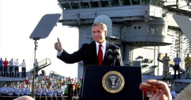 George W. Bush, as US President, gives thumbs up as he declares end of major combat in Iraq aboard aircraft carrier USS Abraham Lincoln, off California coast, photo