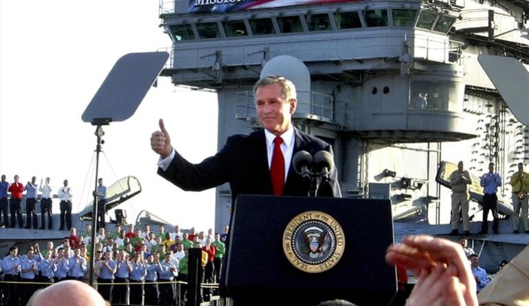 George W. Bush, as US President, gives thumbs up as he declares end of major combat in Iraq aboard aircraft carrier USS Abraham Lincoln, off California coast, photo