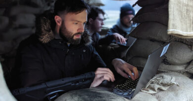 Man at laptop in a defense bunker