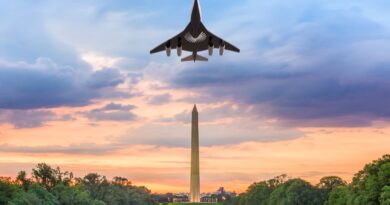 plane in flight over Washington Monument