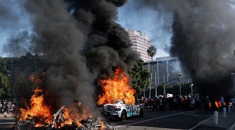 Waymo cars burn during immigration raid protests on June 08, 2025 in Los Angeles, California. Tensions in the city remain high after the Trump administration called in the National Guard against the wishes of city leaders following two days of clashes with police during a series of immigration raids.
