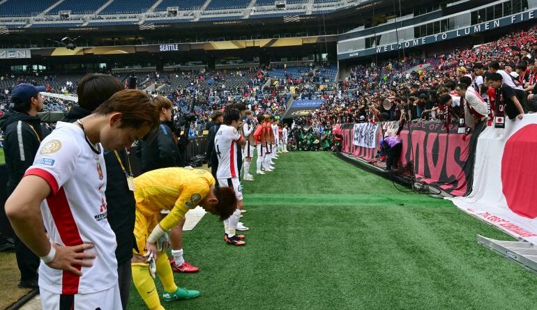 Urawa Red Diamonds players acknowledge their supporters at the end of the FIFA Club World Cup 2025 Group E football match between Italy's Inter Milan and Japan's Urawa Red Diamonds at the Lumen Field stadium in Seattle on June 21, 2025. (Photo by Pablo PORCIUNCULA / AFP)