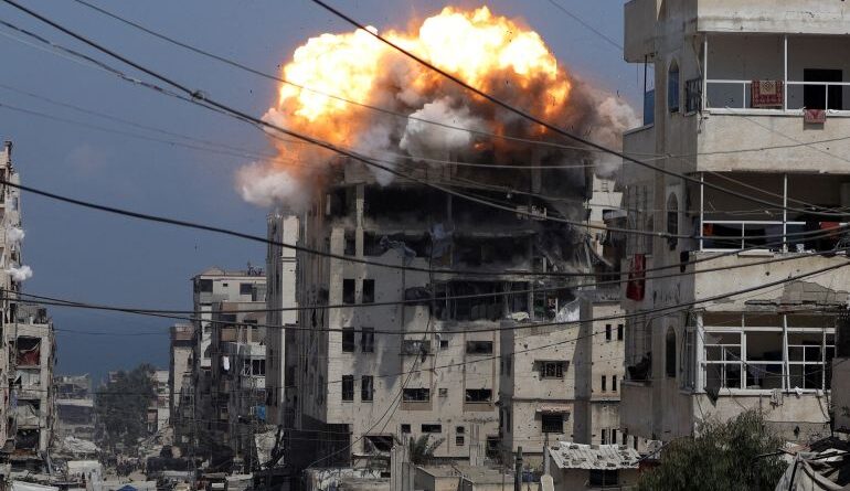 Smoke and flames rise from a residential building hit by an Israeli strike, in Gaza City July 21, 2025. REUTERS/Khamis Al-Rifi TPX IMAGES OF THE DAY